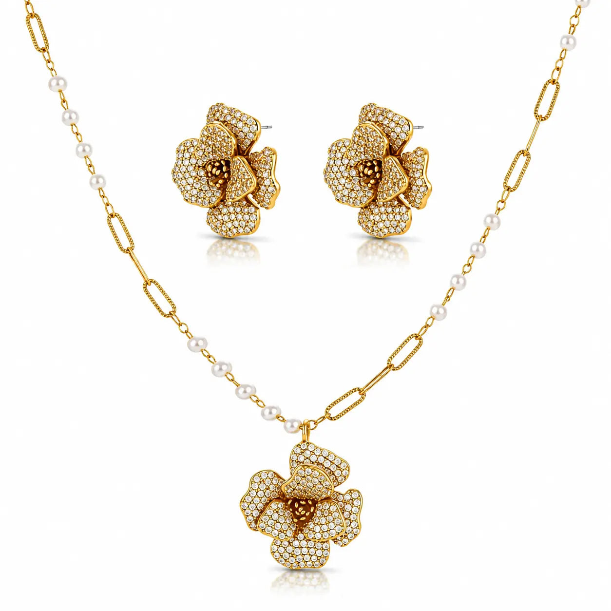 Gold-tone floral jewelry set with a pendant necklace, matching stud earrings, and a chain featuring small white pearls, shown on a clean white background.