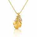 A gold pendant necklace featuring a textured leaf design adorned with small clear stones, suspended from a gold ball chain on a white background with a soft reflection below.