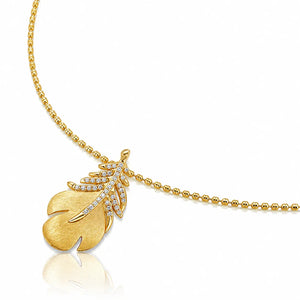 A gold leaf pendant necklace on a delicate gold beaded chain, featuring a textured gold leaf pendant adorned with small clear crystals, shown on a clean white background with a soft reflection.