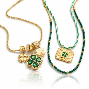 Two St. Patrick's Day themed necklaces displayed on a reflective white surface.