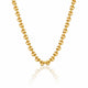 A gold chain necklace with a textured, knotted link design, displayed on a clean white background with a soft reflection below.