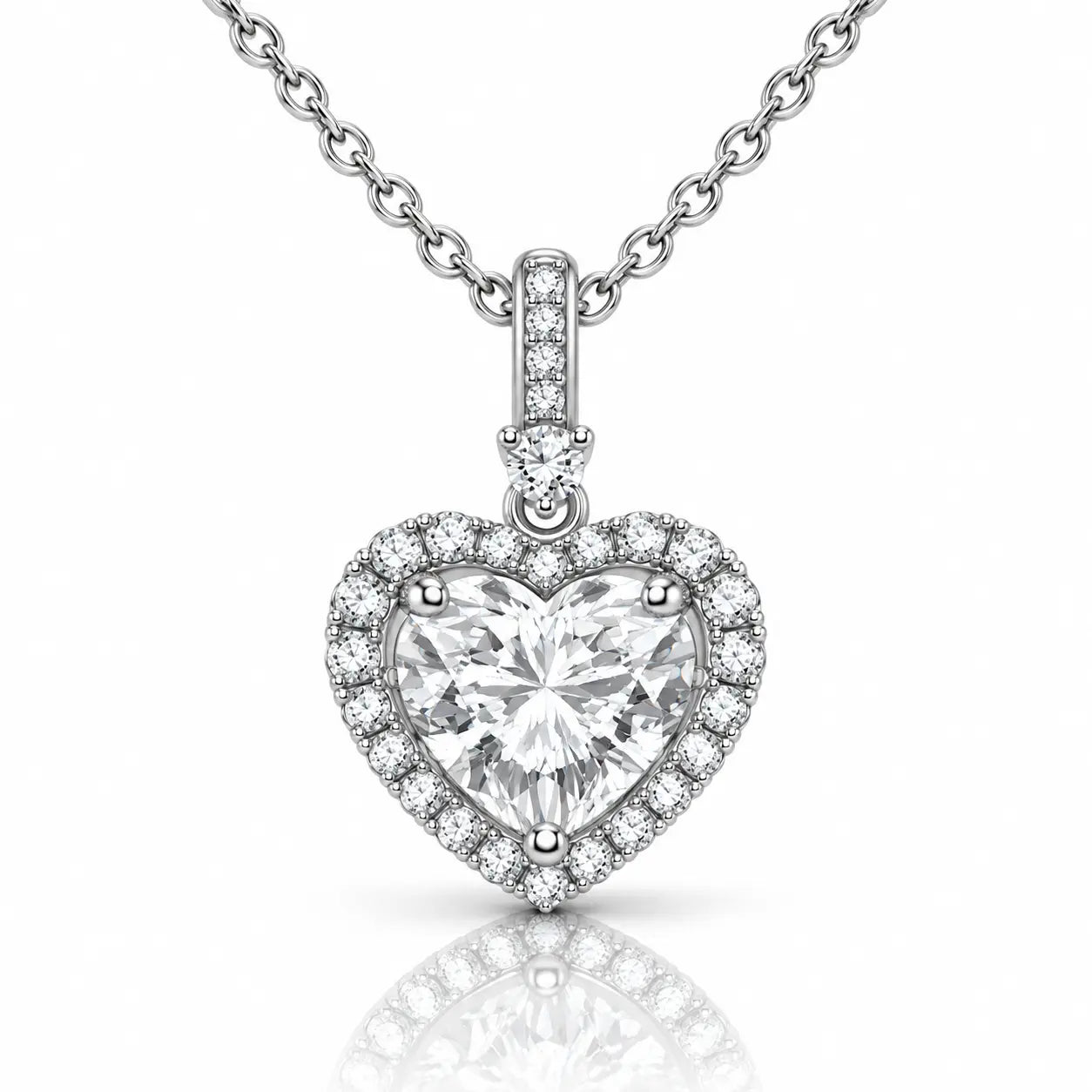 A heart-shaped diamond pendant necklace with a silver-toned halter setting and a matching chain, shown on a clean white background with a soft reflection below.