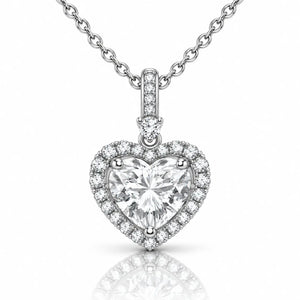 A heart-shaped diamond pendant necklace with a silver-toned halter setting and a matching chain, shown on a clean white background with a soft reflection below.