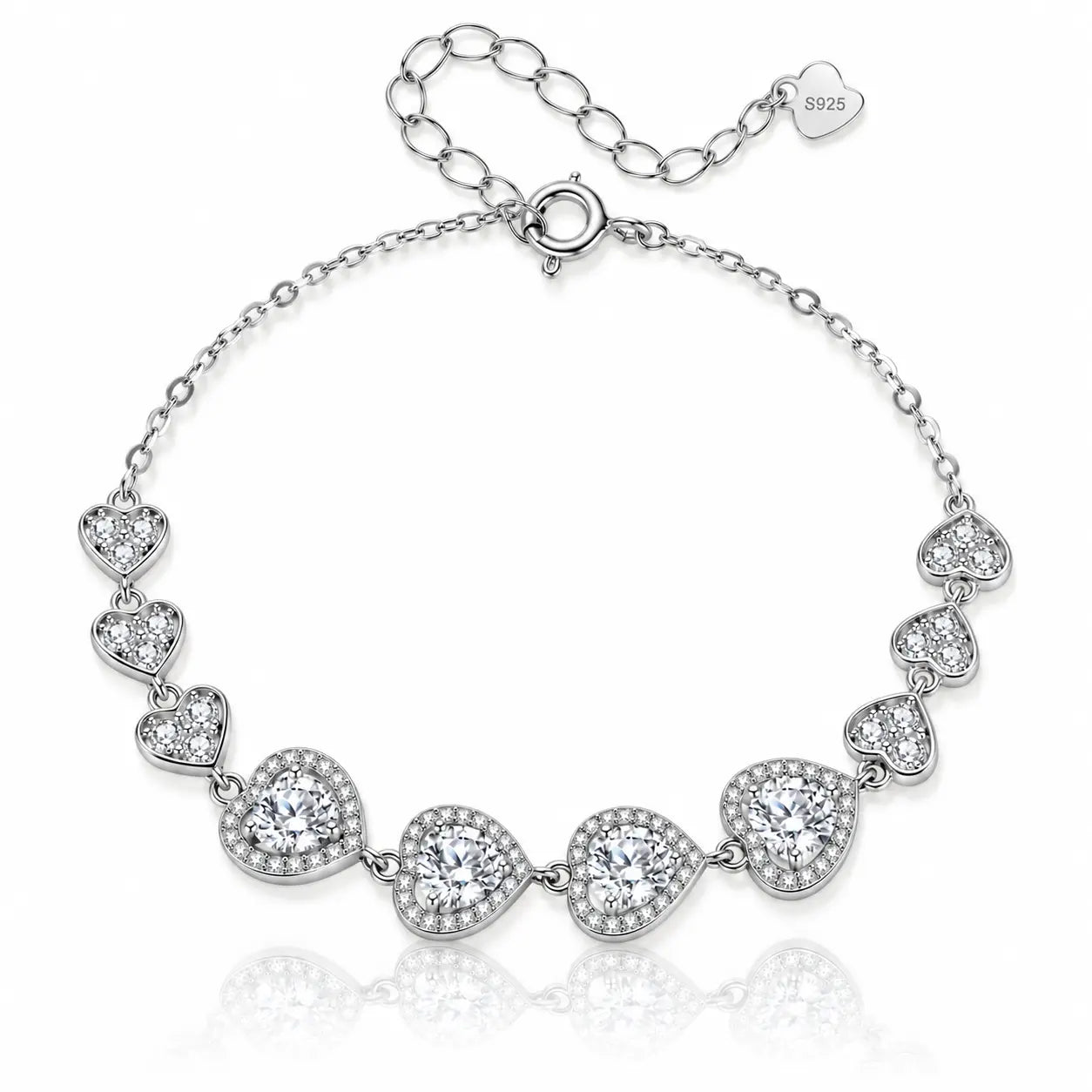 A silver-tone chain bracelet featuring seven heart-shaped settings, each adorned with clear stones, displayed on a clean white background with a soft reflection.