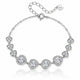 A silver-tone chain bracelet featuring seven heart-shaped settings, each adorned with clear stones, displayed on a clean white background with a soft reflection.