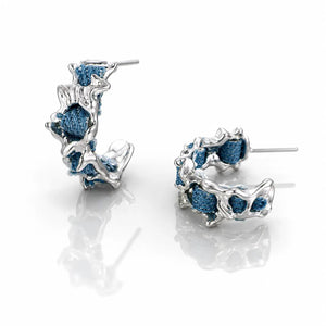 Pair of silver hoop earrings with blue gemstones on a white background