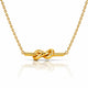 A gold necklace with a polished knot pendant on a fine link chain, displayed against a clean white background with a soft reflection below.