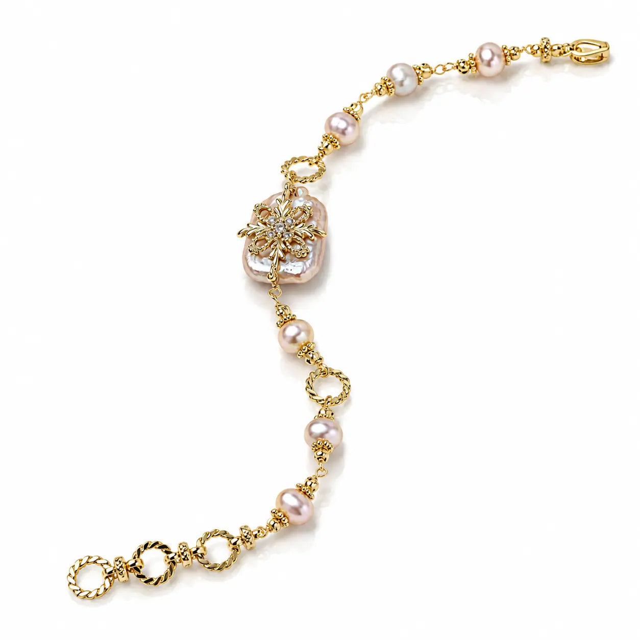 A gold chain bracelet featuring pink freshwater pearls, a central gold floral motif with a clear crystal, and a lobster clasp, shown on a white background.