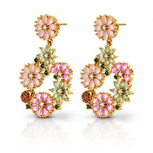 Ornate earrings with floral designs and gold accents on a white background
