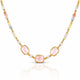 A gold-tone beaded necklace featuring three central light pink rectangular gemstones, flanked by small white pearls and multicolored beads in pastel shades of yellow, blue, and peach, set against a clean white background with a soft reflection below.