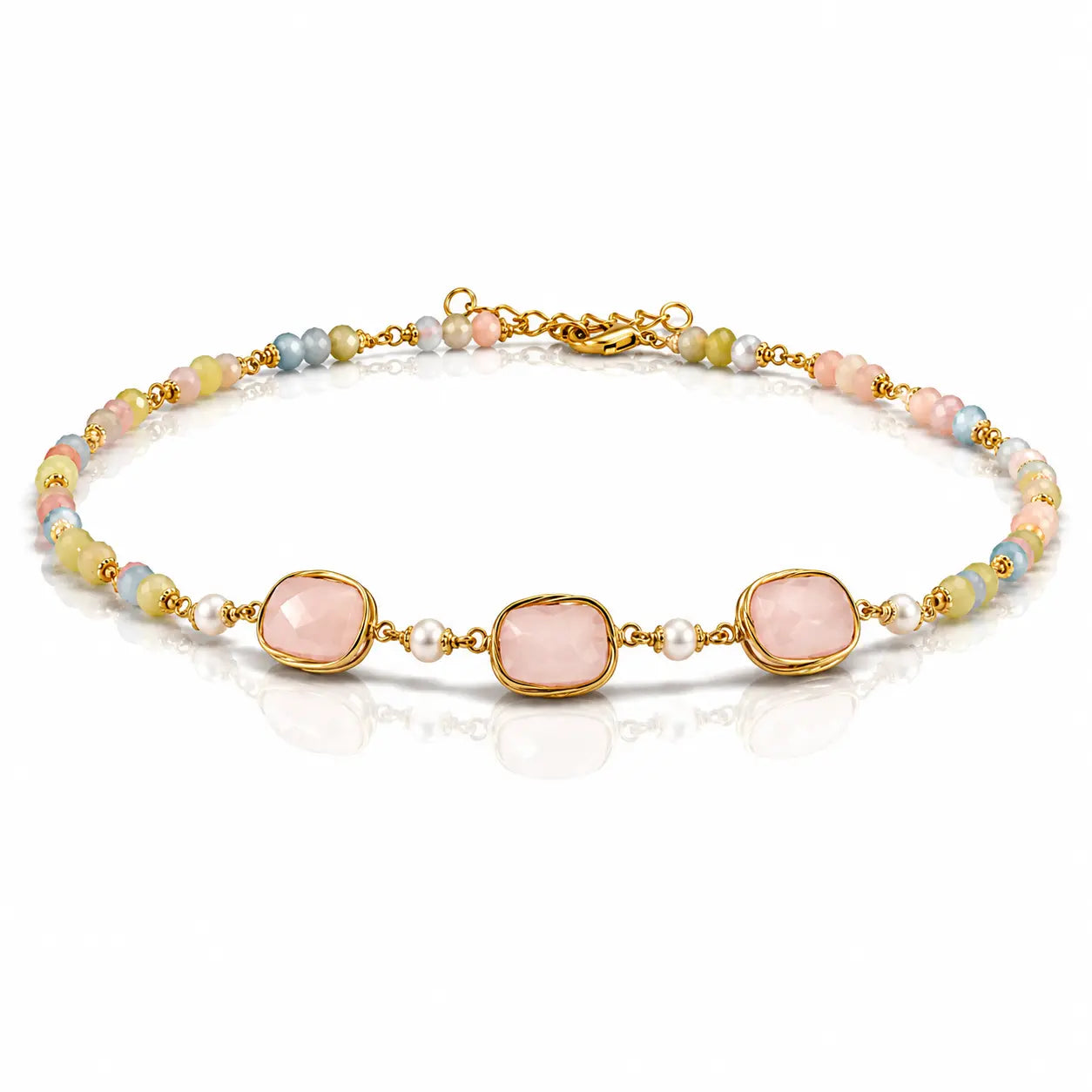 A gold-plated beaded bracelet featuring three large, rounded pale pink stones in bezel settings, accented by small white pearls and pastel-colored beads in pink, blue, yellow, and green.