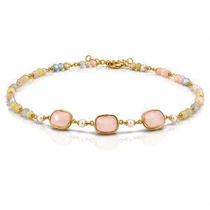 A gold-plated beaded bracelet featuring three large, rounded pale pink stones in bezel settings, accented by small white pearls and pastel-colored beads in pink, blue, yellow, and green.