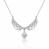 A silver-toned necklace featuring an ornate filigree crescent pendant adorned with small clear stones and a dangling round-cut clear gemstone, shown on a white background with a soft reflection below.