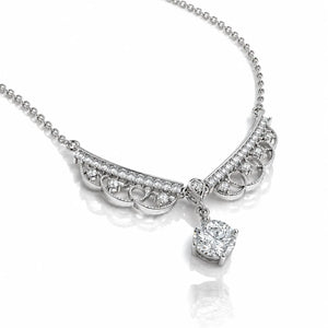 A silver-toned necklace featuring an ornate curved pavé bar with a single large heart-shaped diamond pendant, displayed on a clean white background with a soft reflection.