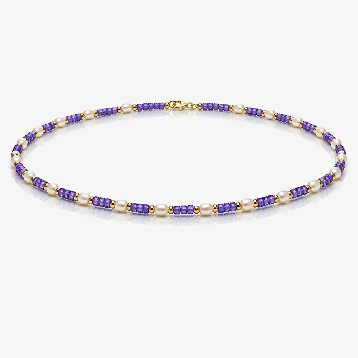Beaded necklace with purple and gold beads on a white background