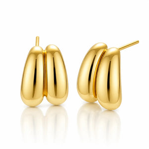 A pair of polished gold stud earrings with a double-bar design, shown from front and side angles on a clean white background with a soft reflection below.