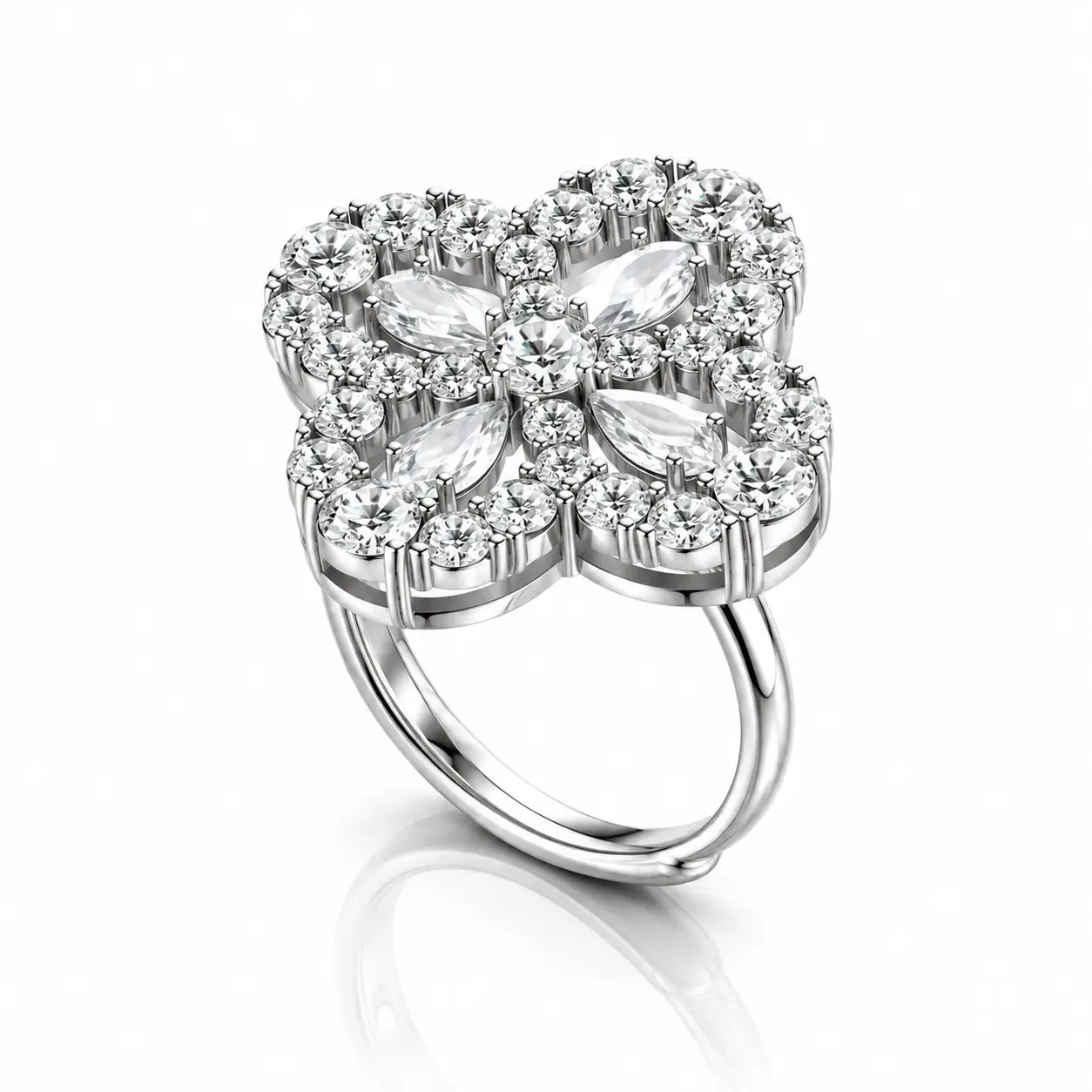 A silver four-petal flower ring featuring marquise-cut and round-cut clear gemstones, set against a clean white background with a soft reflection below.