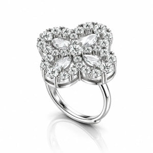A silver four-petal flower ring featuring marquise-cut and round-cut clear gemstones, set against a clean white background with a soft reflection below.