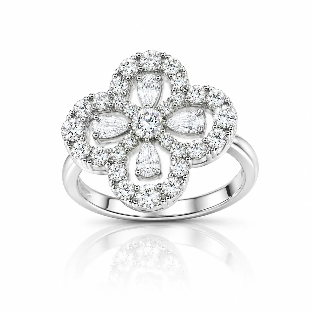 A silver-toned four-petal flower ring set with numerous clear diamonds, shown on a clean white background with a soft reflection below.
