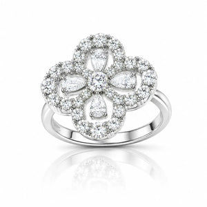 A silver-toned four-petal flower ring set with numerous clear diamonds, shown on a clean white background with a soft reflection below.