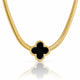 A gold chain necklace featuring a black four-leaf clover pendant with a textured gold border, displayed on a clean white background with a soft reflection below.