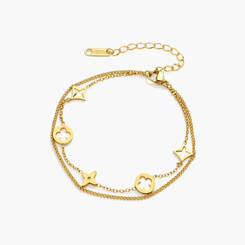 18K gold plated double chain bracelet with star and floral charms on white background