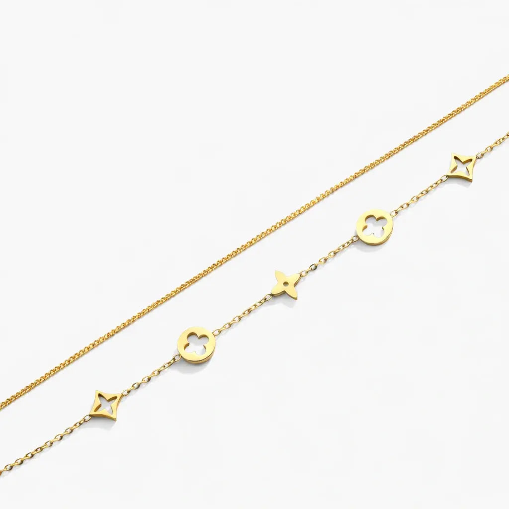 18K gold plated bracelet with star and floral charms on delicate chain, on white background