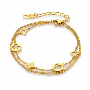 A gold double-layer chain bracelet with star and clover motifs, displayed on a clean white background.