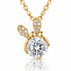 A gold pendant necklace featuring a bunny-shaped charm with a large round clear center stone and smaller clear stones along the ears and bow, shown on a white background with a soft reflection below.
