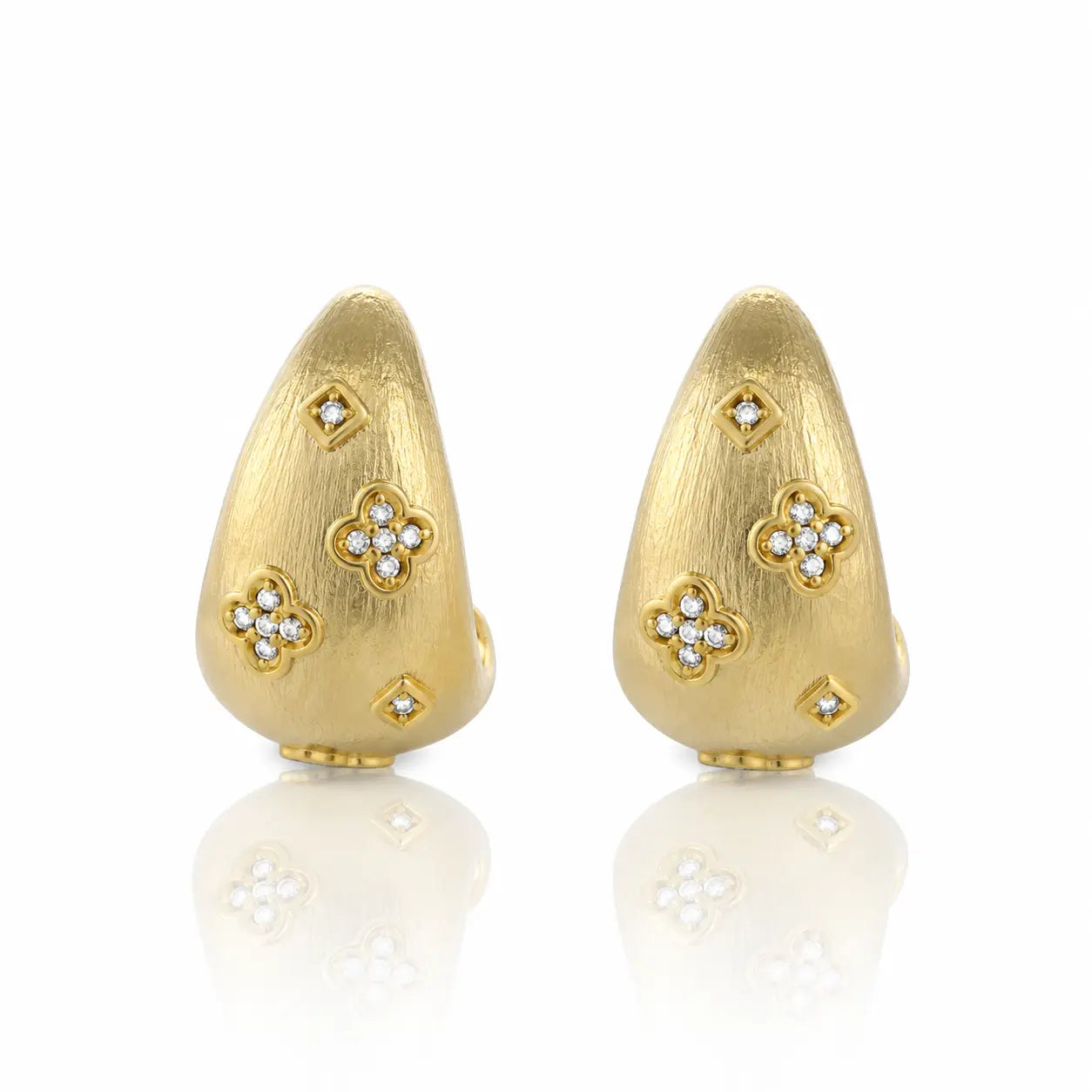 Pair of gold earrings with diamond accents on a white background