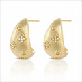 Gold hoop earrings with diamond-like stone designs on a white background