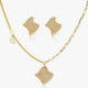 Gold necklace and earrings set on a white background