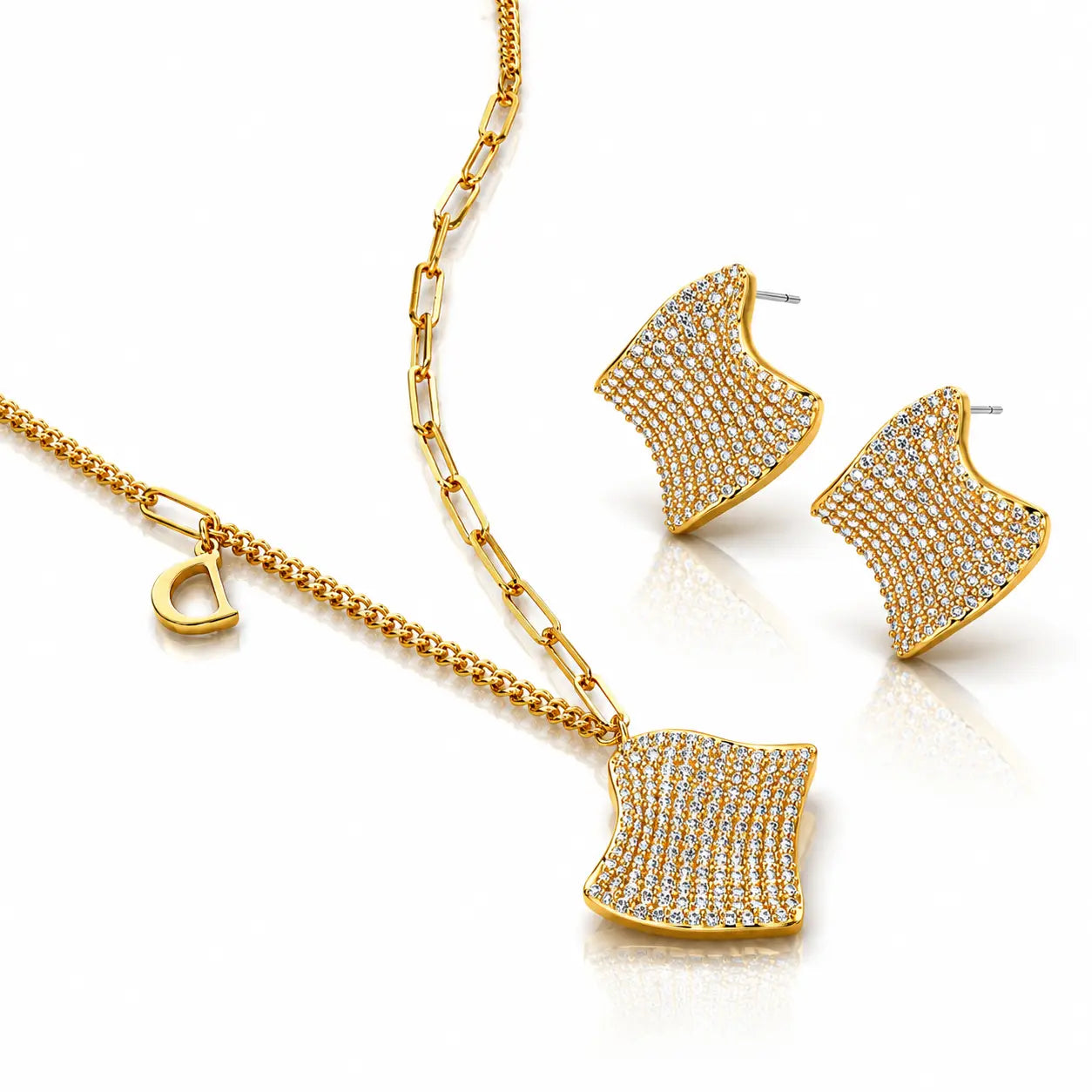 Gold necklace and earrings set on a white background