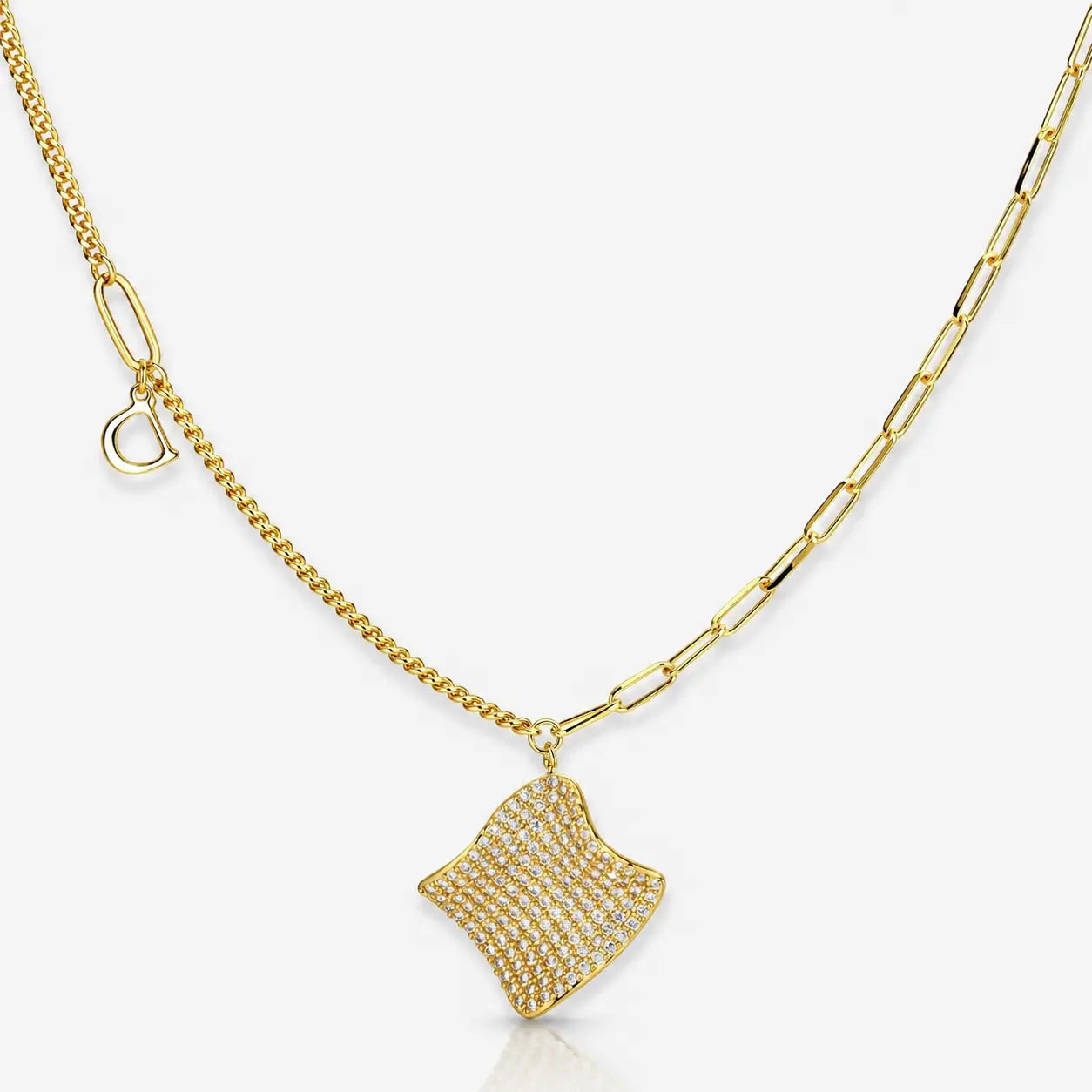 Gold necklace with a textured pendant on a white background