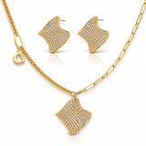 Gold necklace and earrings set on a white background