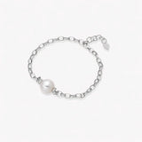 Rhodium-plated silver chain bracelet with single white pearl and adjustable clasp on white background