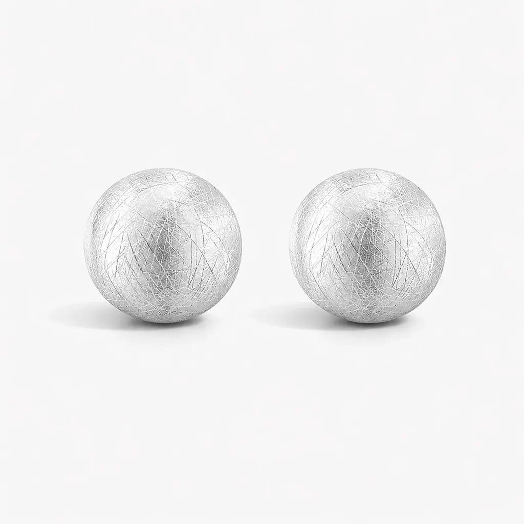 Pair of round brushed 925 sterling silver dome clip earrings on white background