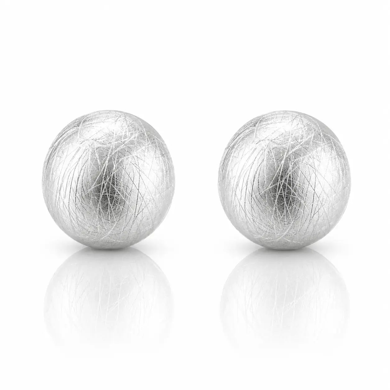 A pair of spherical silver earrings with a textured, fibrous hair-like surface, displayed on a clean white background with soft reflections below.