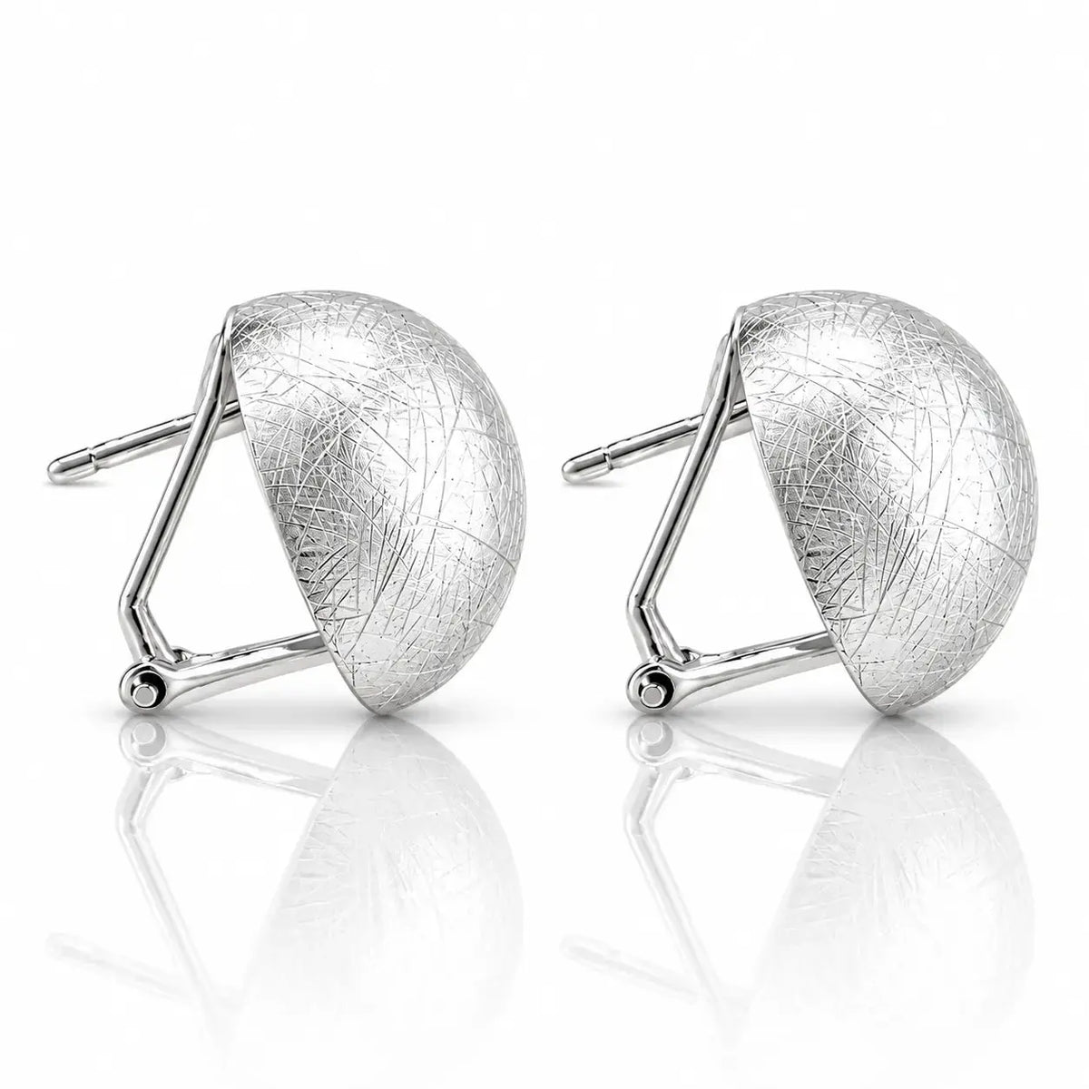 A pair of silver geometric stud earrings with a textured, crackled finish on a reflective white surface.