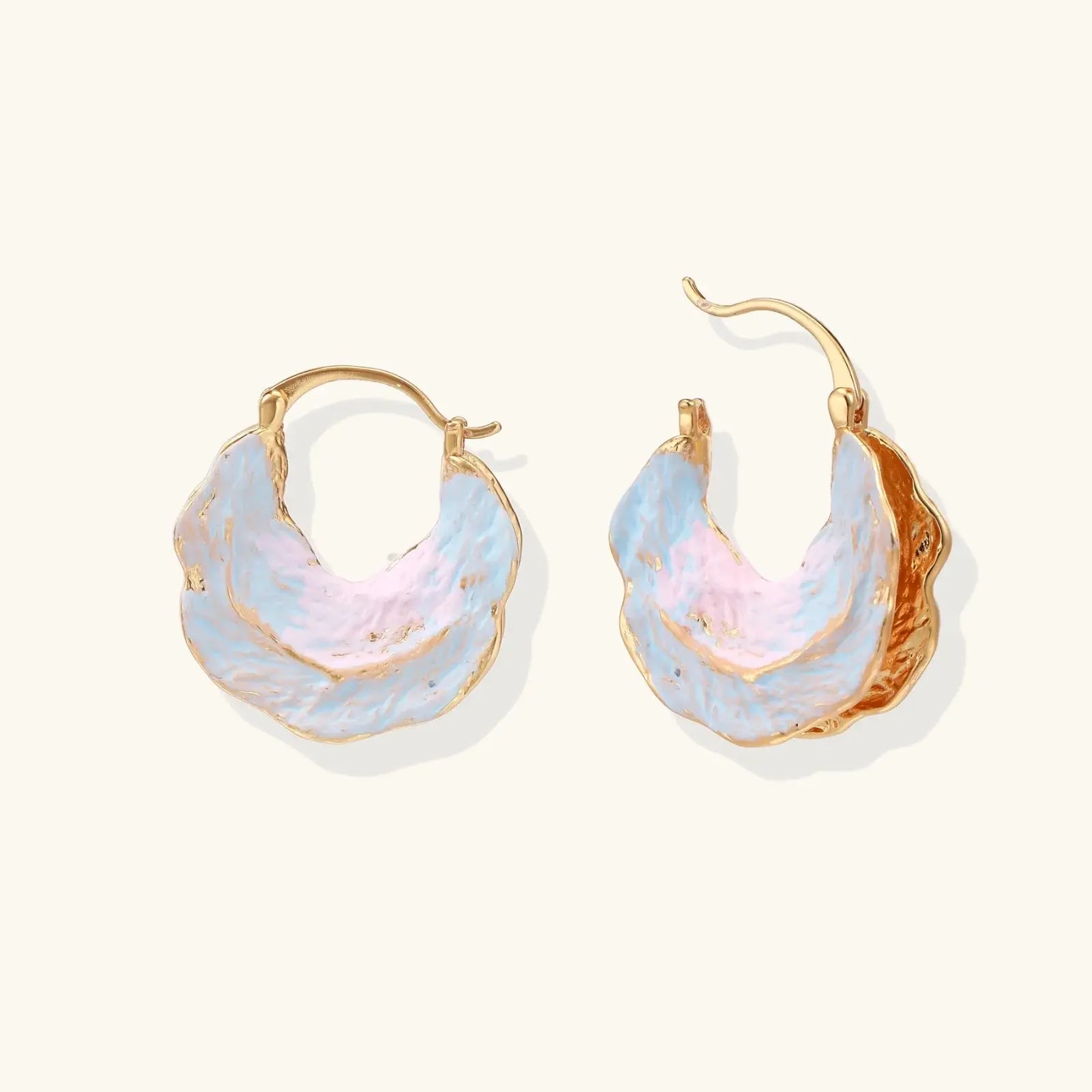 Gold hoop earrings with pastel blue and pink gradient on a white background