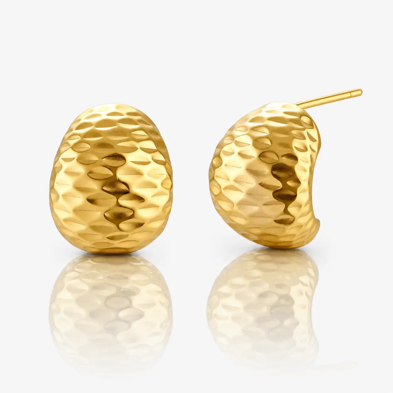Pair of gold earrings on a reflective surface with a white background