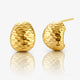 Pair of gold earrings on a reflective surface with a white background