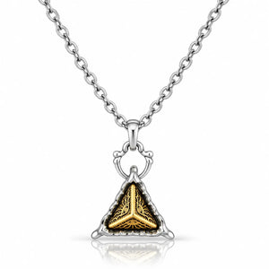 A silver-toned chain necklace with a triangular pendant featuring a gold-toned tree design set against a textured silver background, shown on a clean white background with a soft reflection.