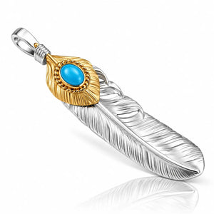 A two-tone feather pendant featuring a textured silver feather body, a gold-toned accent cap with a round turquoise blue stone, and a silver bail, shown on a white background with a soft reflection.
