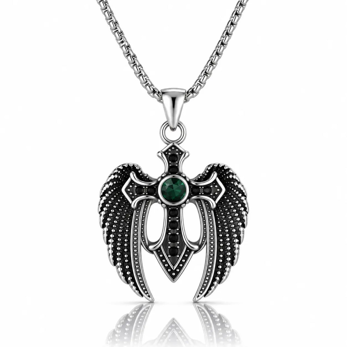 A silver-toned angel wing pendant necklace with a central green gemstone and black accents, suspended from a silver chain on a white background with a reflection below.