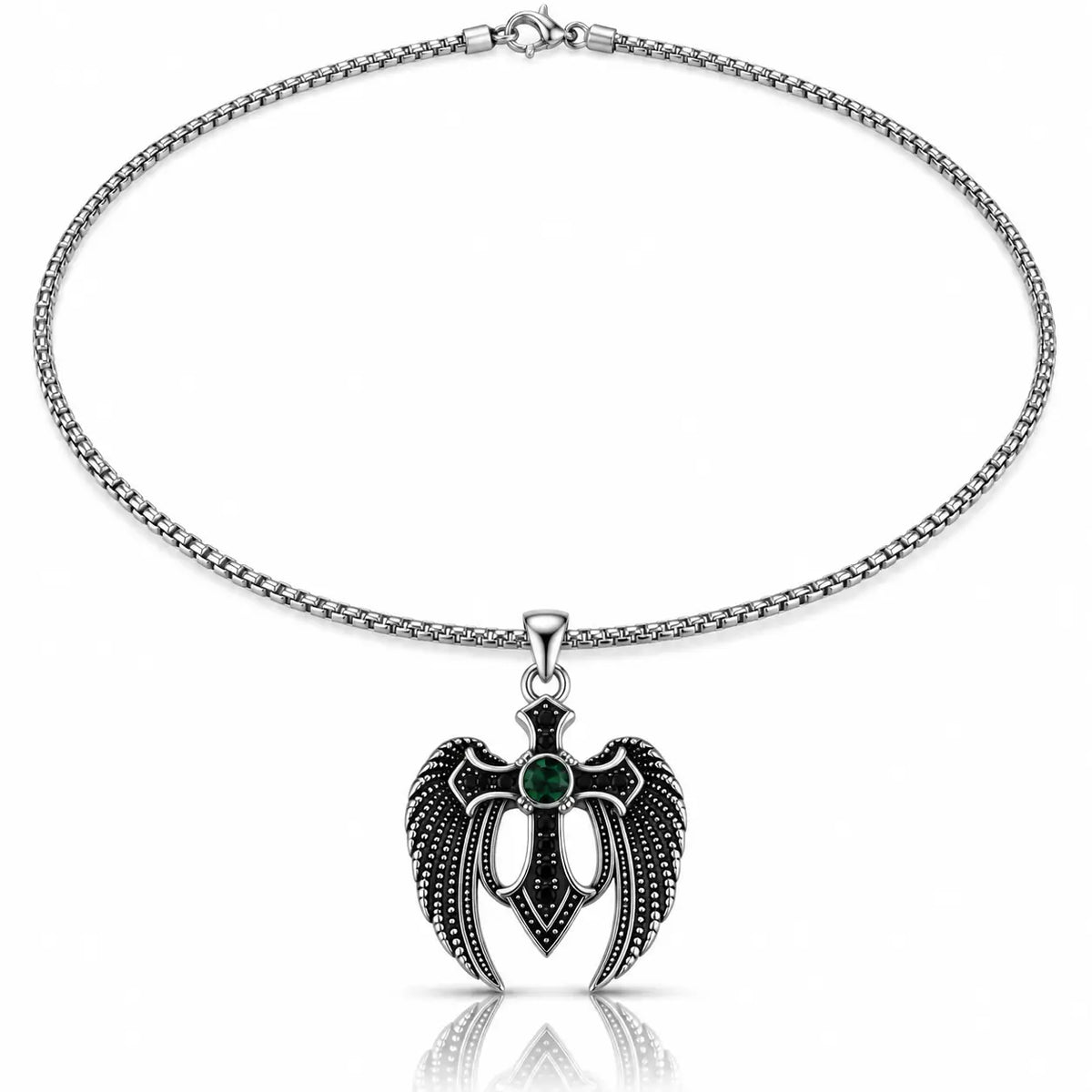 A silver-toned chain necklace with a winged cross pendant featuring a dark green oval gemstone at the center, shown on a clean white background with a subtle reflection below.