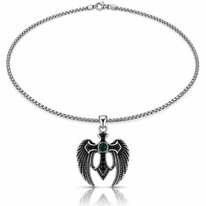A silver-toned chain necklace with a winged cross pendant featuring a dark green oval gemstone at the center, shown on a clean white background with a subtle reflection below.