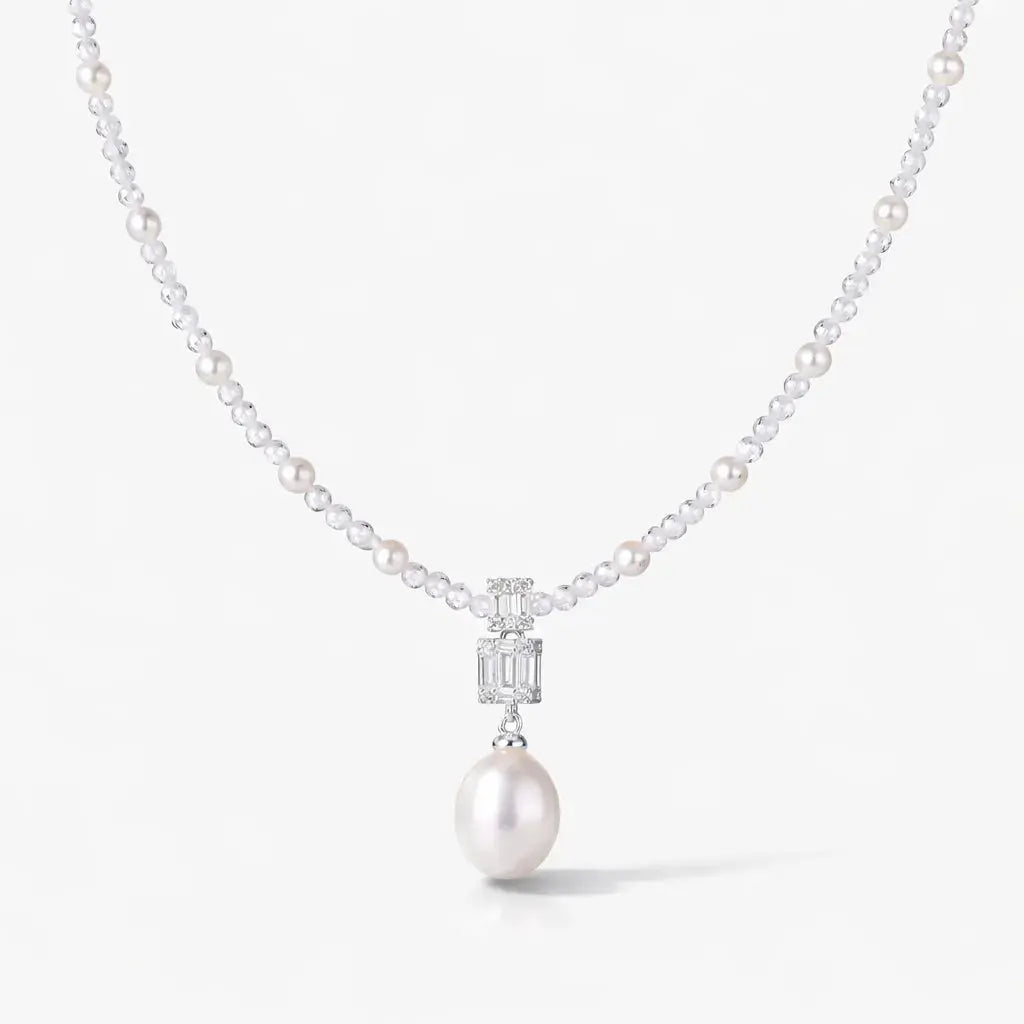 Silver pearl drop necklace with gemstone accents and elegant pearl strand