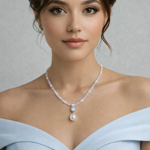 Woman wearing a moonlit pearl drop 925 silver necklace with off-shoulder dress