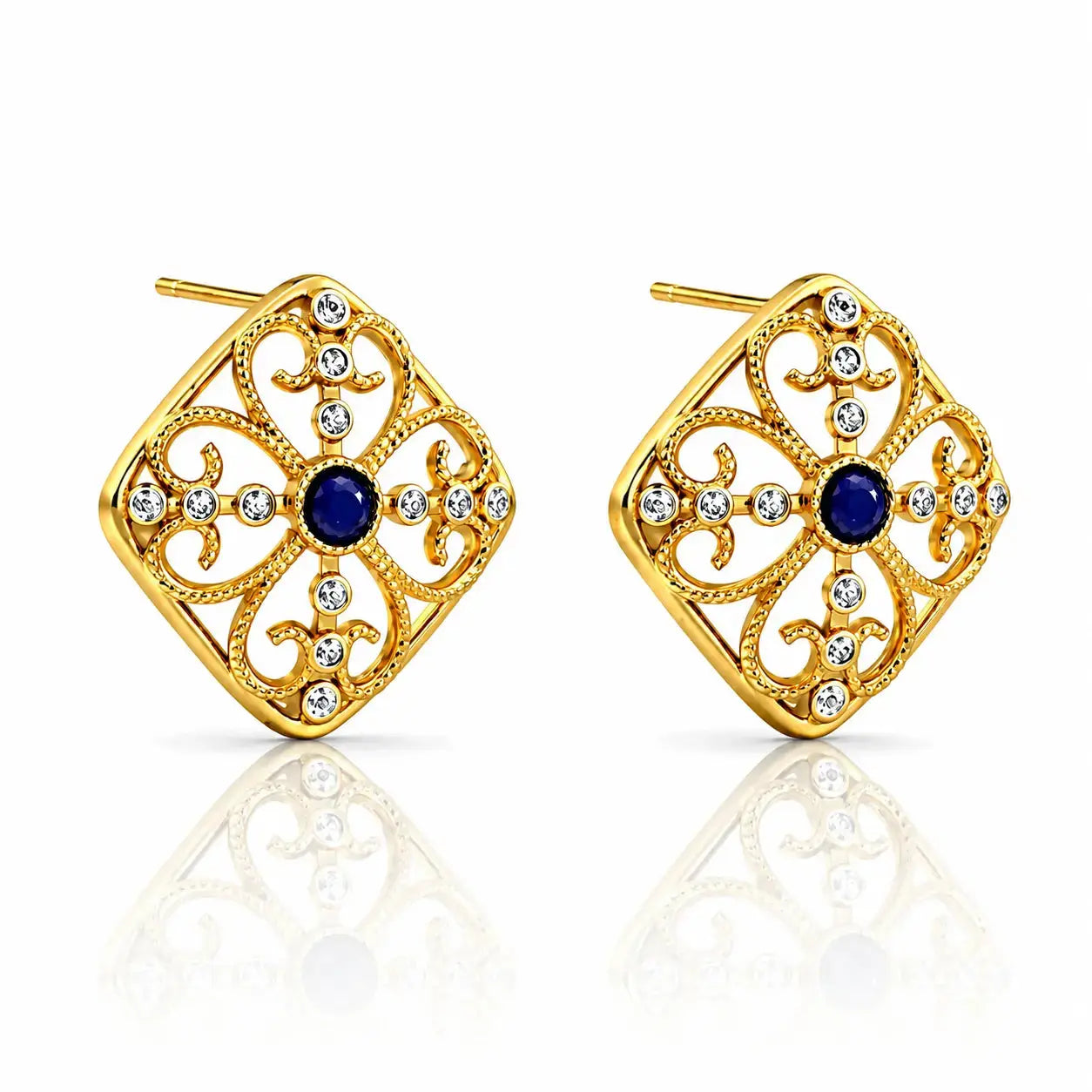 A pair of gold filigree stud earrings with a central round blue gemstone and small clear rhinestone accents, shown on a white background with a soft reflection below.